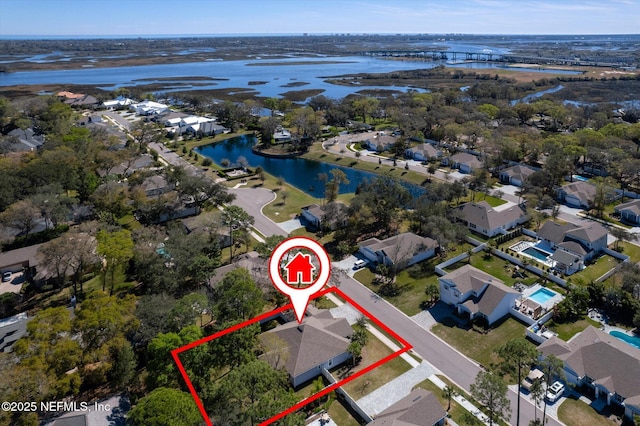 drone / aerial view featuring a water view and a residential view