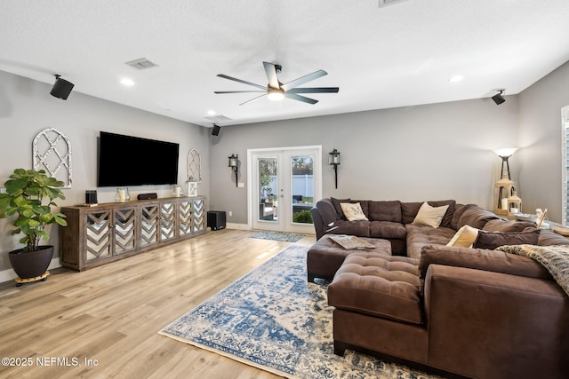 living room featuring baseboards, visible vents, ceiling fan, wood finished floors, and french doors