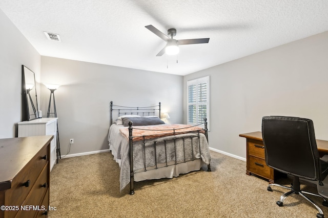 bedroom with light carpet, visible vents, and a textured ceiling