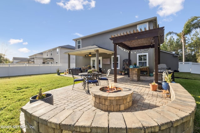 rear view of property featuring a fire pit, a lawn, fence, a patio area, and a pergola