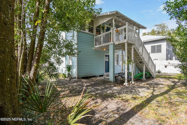 rear view of house featuring stairs