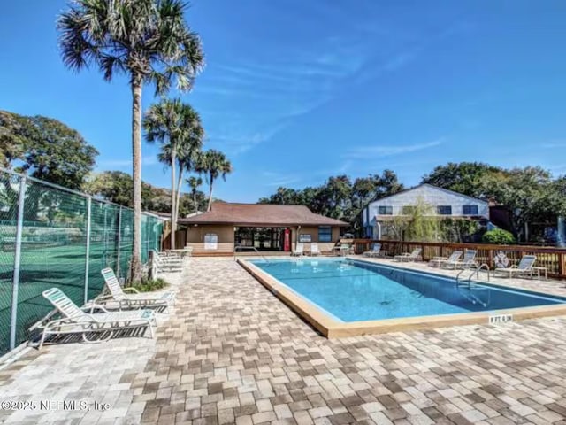 pool with fence and a patio