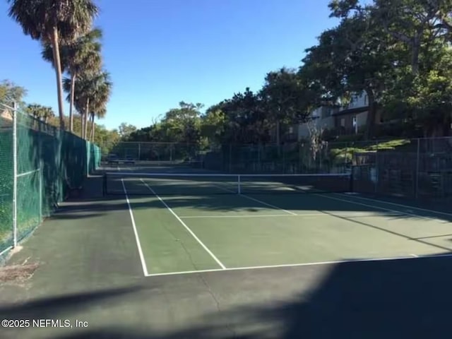 view of tennis court with fence