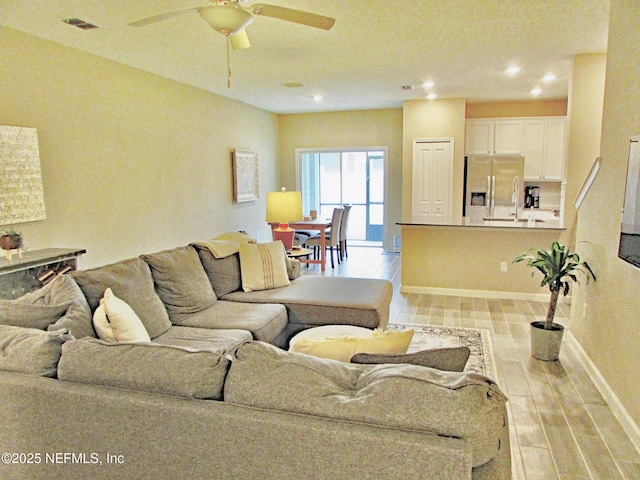 living room featuring wood finish floors, recessed lighting, visible vents, ceiling fan, and baseboards