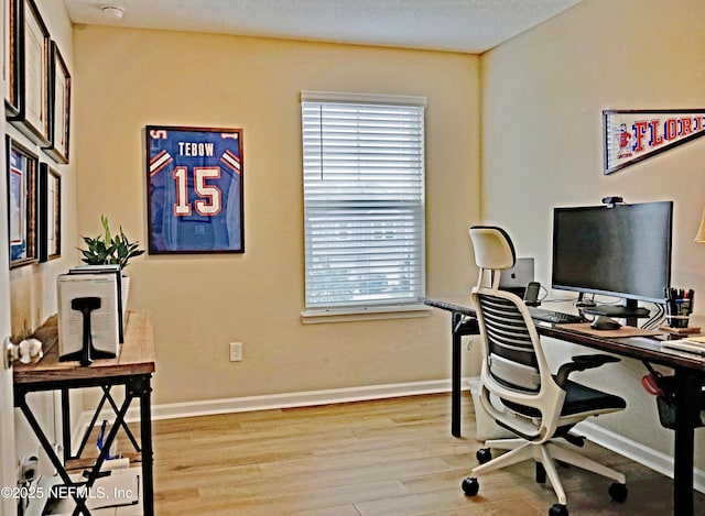 office space featuring baseboards and wood finished floors