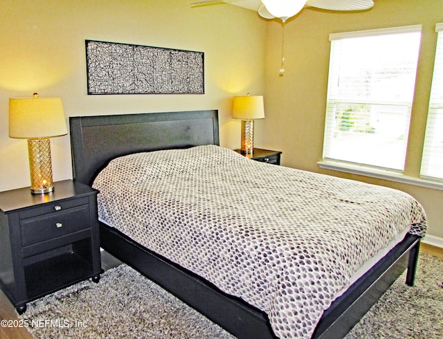 bedroom featuring a ceiling fan and baseboards