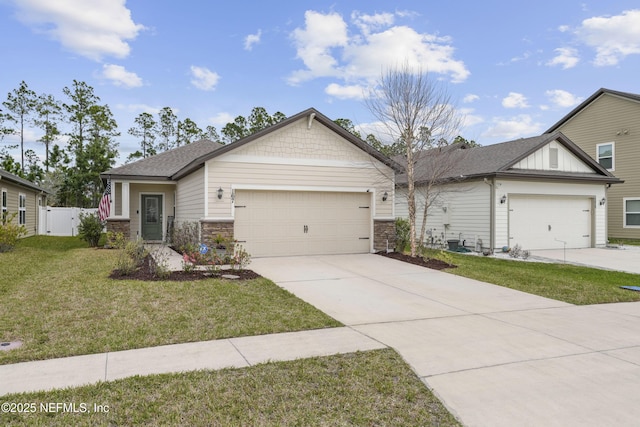 view of front of home with a garage, fence, concrete driveway, roof with shingles, and a front lawn