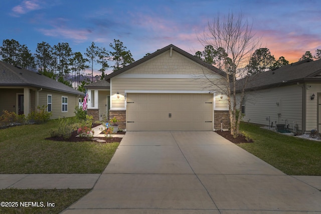 view of front of house featuring driveway, stone siding, an attached garage, and a front yard