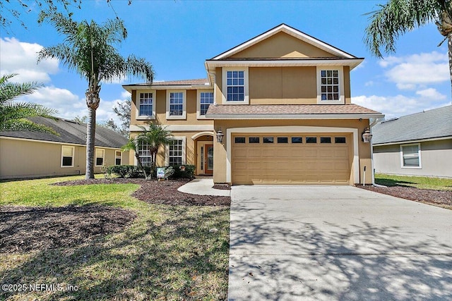 traditional-style house with concrete driveway, an attached garage, french doors, and stucco siding