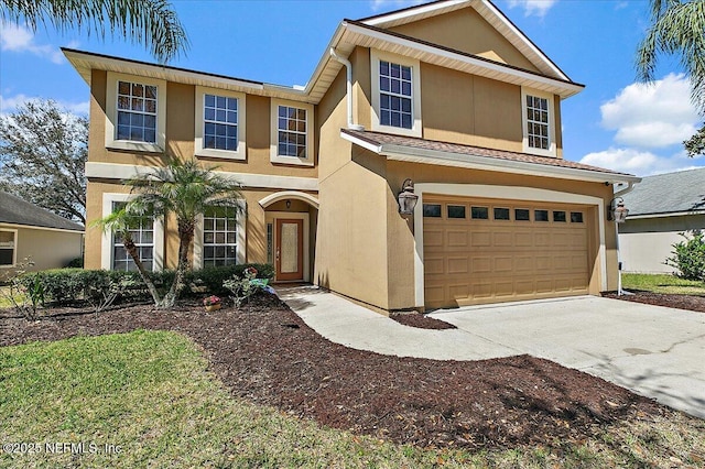 traditional-style home featuring stucco siding, an attached garage, and concrete driveway