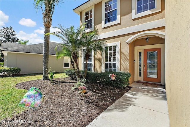 entrance to property with stucco siding