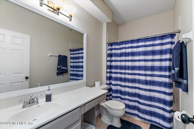 bathroom featuring toilet, vanity, a shower with curtain, tile patterned floors, and a textured ceiling