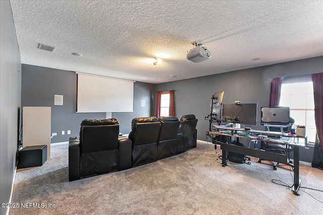 home theater featuring a textured ceiling, carpet, visible vents, and baseboards