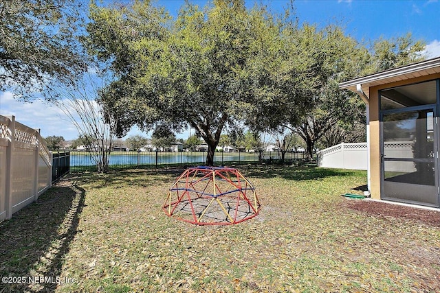 view of yard with a water view and a fenced backyard