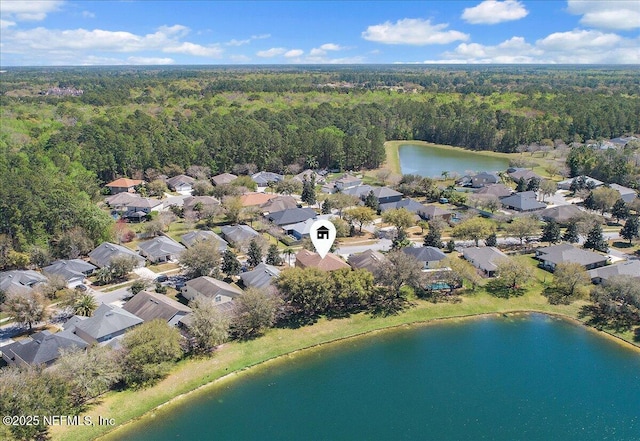 aerial view with a residential view, a forest view, and a water view