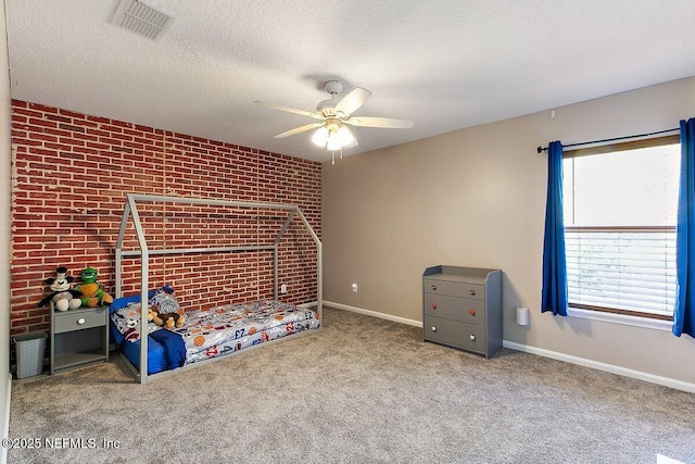 unfurnished bedroom with visible vents, brick wall, baseboards, carpet floors, and a textured ceiling