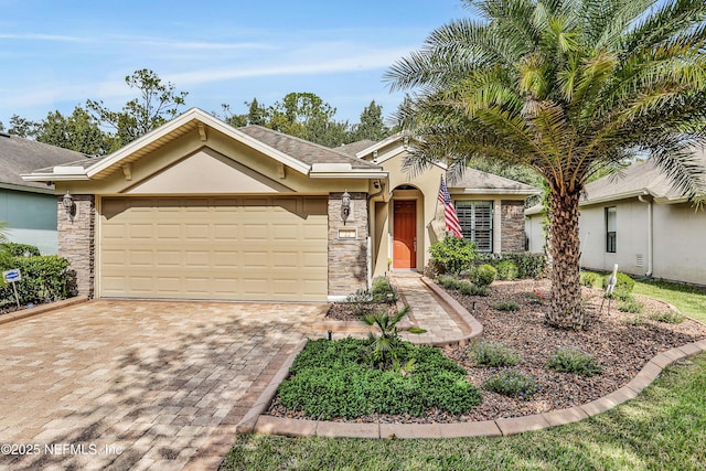 single story home with stucco siding, stone siding, a garage, and driveway