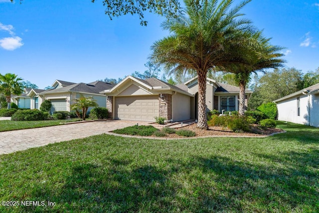 single story home featuring stucco siding, decorative driveway, a front lawn, and an attached garage