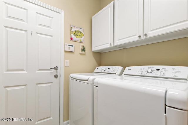 laundry room featuring cabinet space and separate washer and dryer