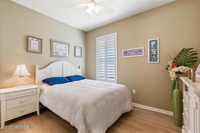 bedroom featuring a ceiling fan, baseboards, and wood finished floors