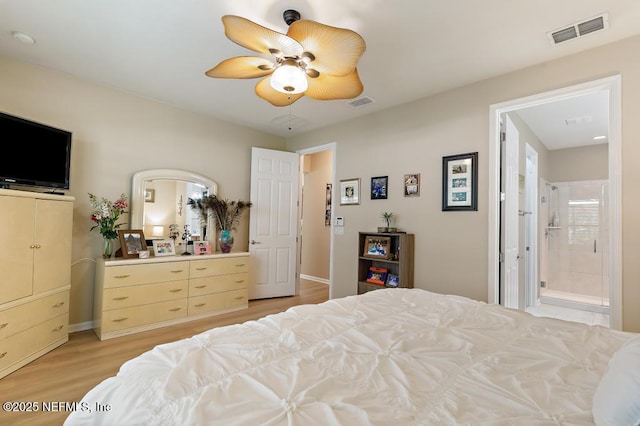 bedroom featuring visible vents, connected bathroom, light wood-type flooring, and a ceiling fan