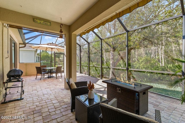 view of patio / terrace featuring outdoor dining space and glass enclosure