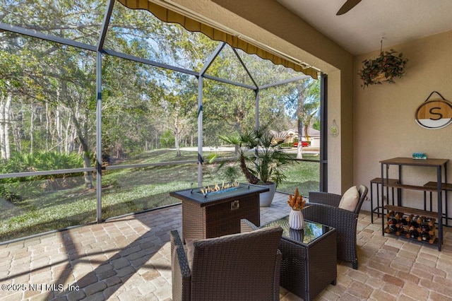 exterior space with glass enclosure and ceiling fan