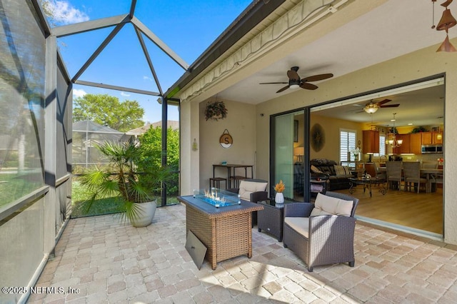 sunroom / solarium featuring ceiling fan