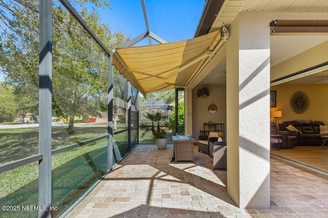 view of patio / terrace featuring glass enclosure and an outdoor hangout area