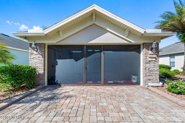 garage with decorative driveway