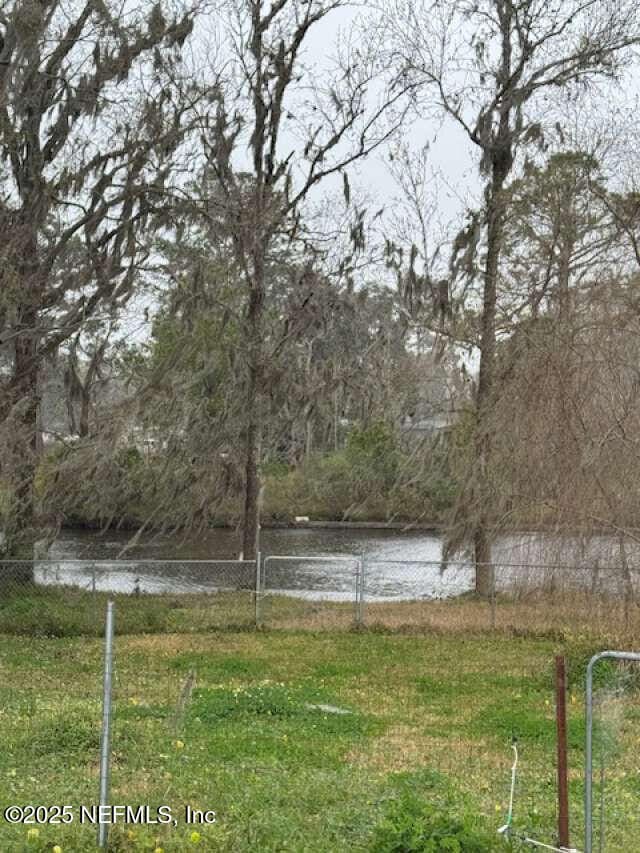 property view of water featuring fence