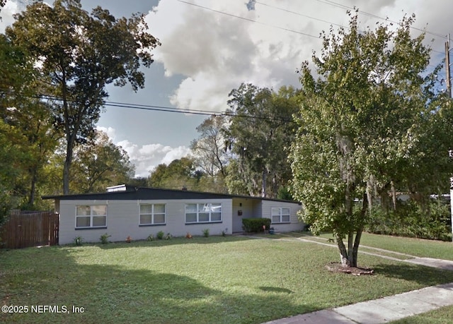 ranch-style home with a front lawn and fence