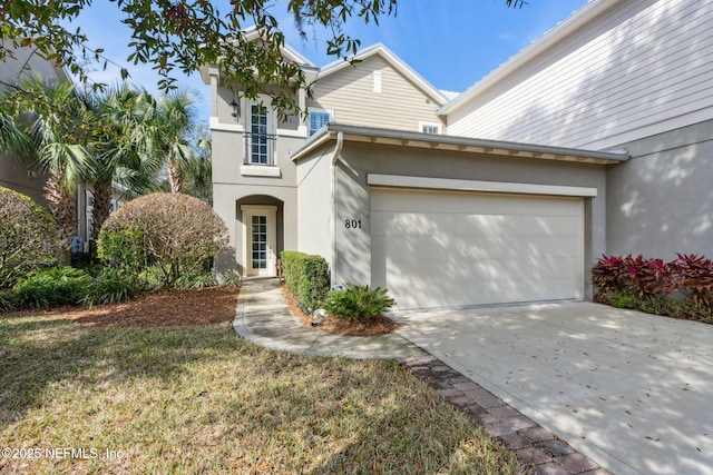 traditional-style house with driveway and stucco siding