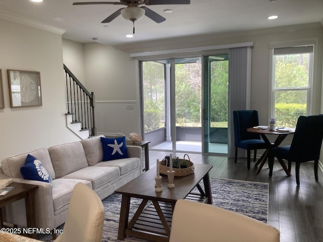 living room with recessed lighting, wood finished floors, a ceiling fan, stairs, and crown molding