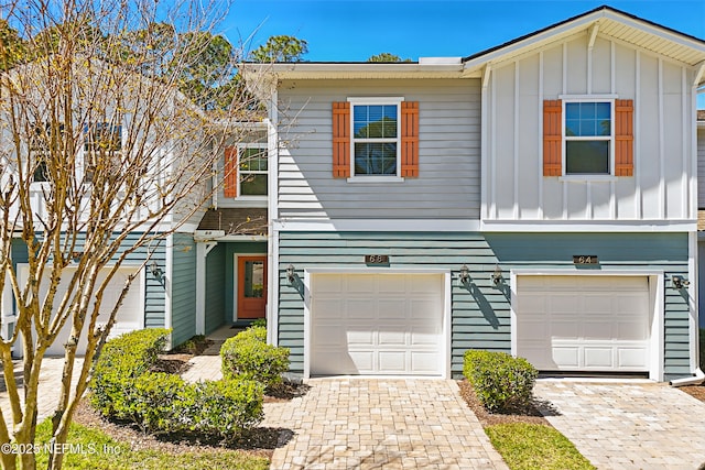 68 Canary Palm Ct, Ponte Vedra, FL 32081 - view of front of property with board and batten siding, driveway, and an attached garage