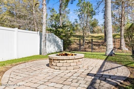 view of patio / terrace featuring a fenced backyard and a fire pit