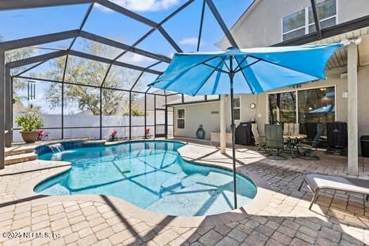 view of pool featuring a lanai, a patio area, and a fenced in pool