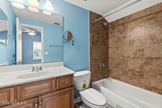 bathroom with a chandelier, shower / bathing tub combination, vanity, and toilet