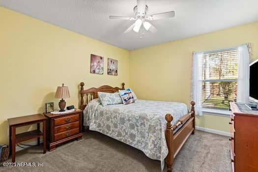 bedroom with carpet flooring, ceiling fan, and baseboards