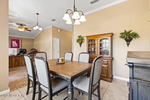 dining room with ceiling fan with notable chandelier, ornamental molding, and light tile patterned floors