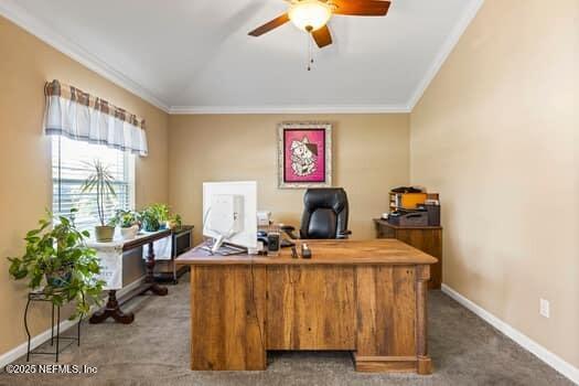 office space with baseboards, ceiling fan, carpet, vaulted ceiling, and crown molding