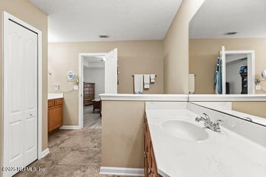 bathroom featuring baseboards and vanity