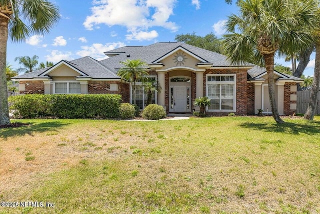 view of front of property with a front yard and brick siding