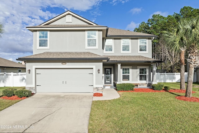 view of front facade featuring concrete driveway, fence, a front lawn, and stucco siding