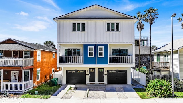 1306 1st St S, Jacksonville Beach, FL 32250 - view of front of home featuring board and batten siding, an attached garage, driveway, and fence