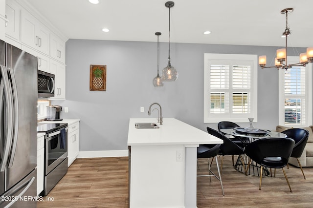 1306 1st St S, Jacksonville Beach, FL 32250 - kitchen with recessed lighting, a sink, stainless steel appliances, light countertops, and light wood-type flooring