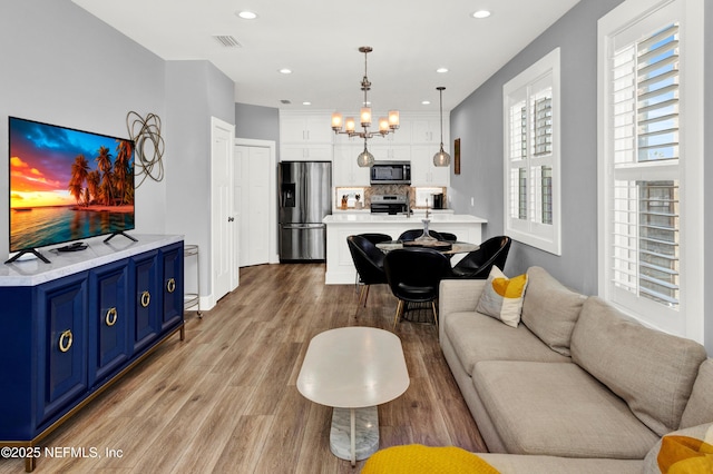 1306 1st St S, Jacksonville Beach, FL 32250 - living room with a notable chandelier, recessed lighting, visible vents, and light wood finished floors