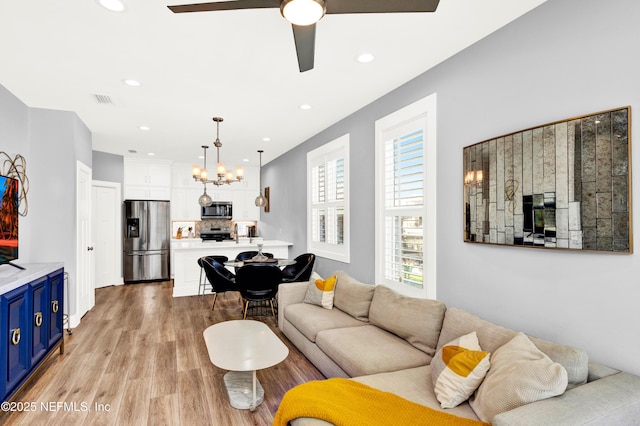 1306 1st St S, Jacksonville Beach, FL 32250 - living room with recessed lighting, ceiling fan with notable chandelier, light wood-type flooring, and visible vents