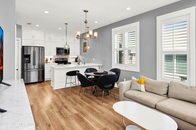 1306 1st St S, Jacksonville Beach, FL 32250 - living room featuring recessed lighting, visible vents, an inviting chandelier, and light wood finished floors