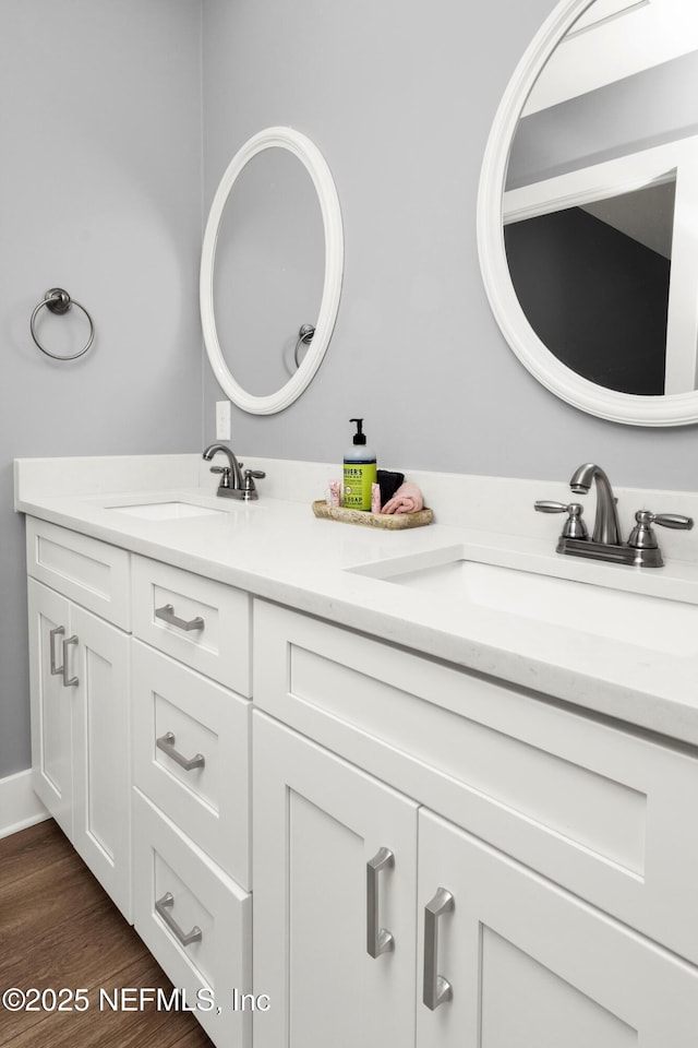 1306 1st St S, Jacksonville Beach, FL 32250 - full bath featuring a sink, baseboards, wood finished floors, and double vanity